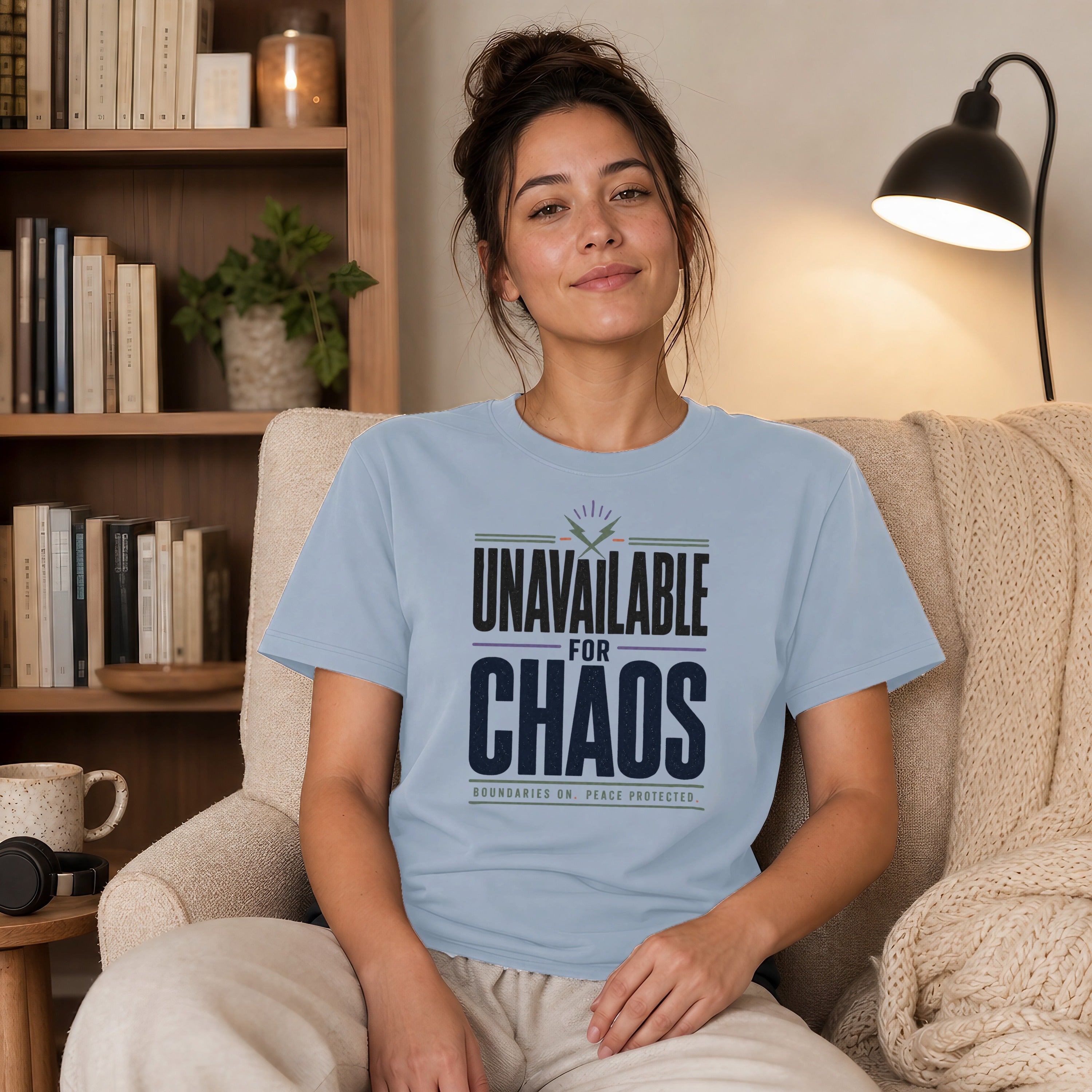 Light blue t-shirt with "Unavailable for Chaos" text, sitting on a model.