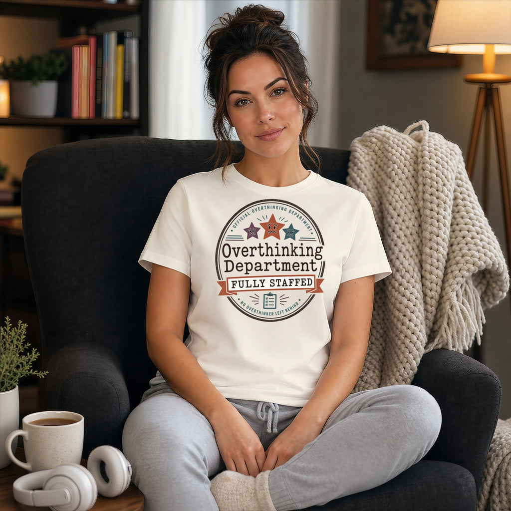 T-shirt reading "Official Overthinking Department Fully Staffed" on a seated woman.
