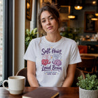 White t-shirt with "Soft Heart, Loud Brain" text and graphic.