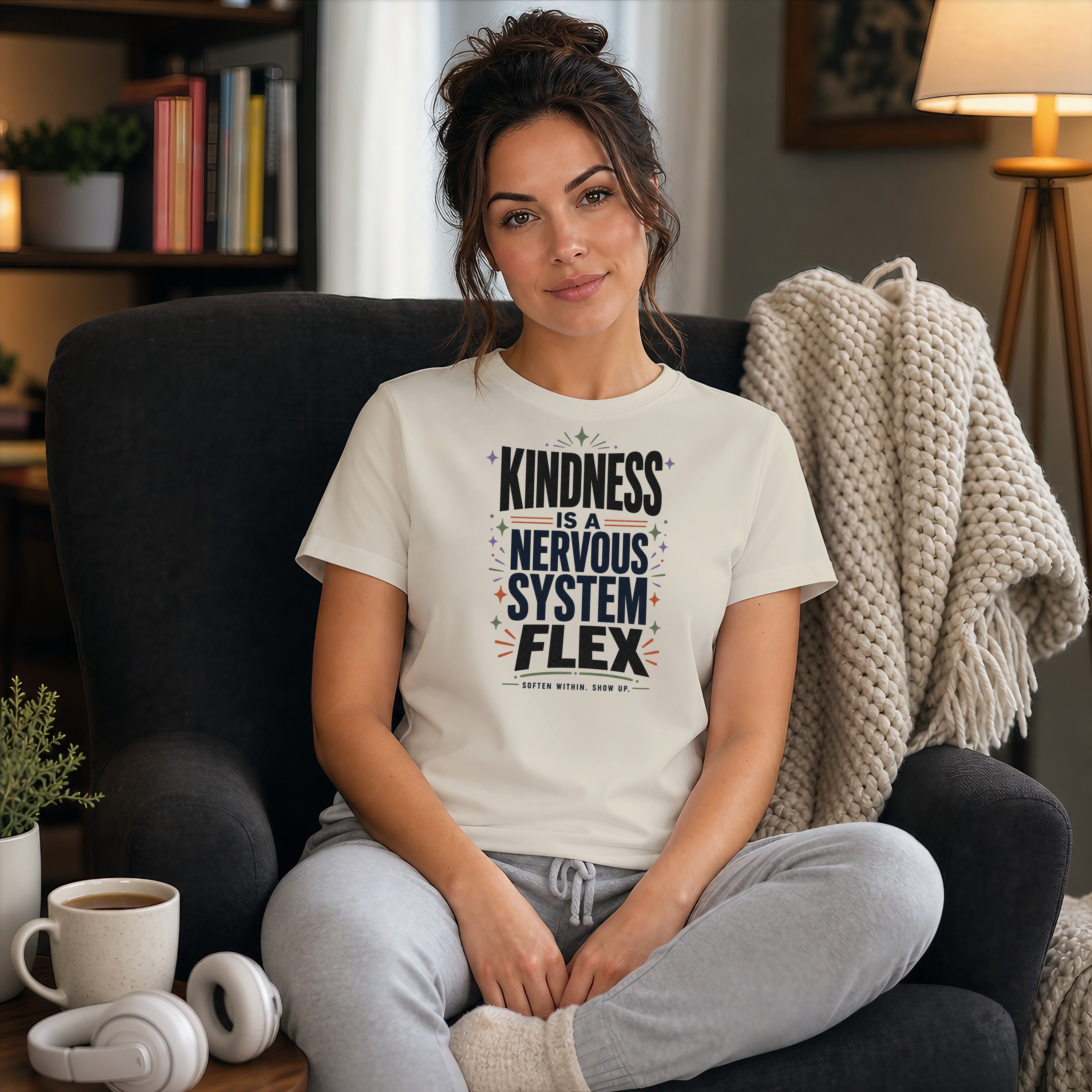 Woman wearing a t-shirt with "Kindness is a Nervous System Flex" text.
