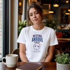 Woman wearing white t-shirt with "Resting Anxious Face" text and graphic.