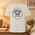 White t-shirt with "Tiny Social Battery Club" circular logo.