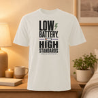 White t-shirt with "LOW BATTERY, HIGH STANDARDS" text and lightning bolt graphic.