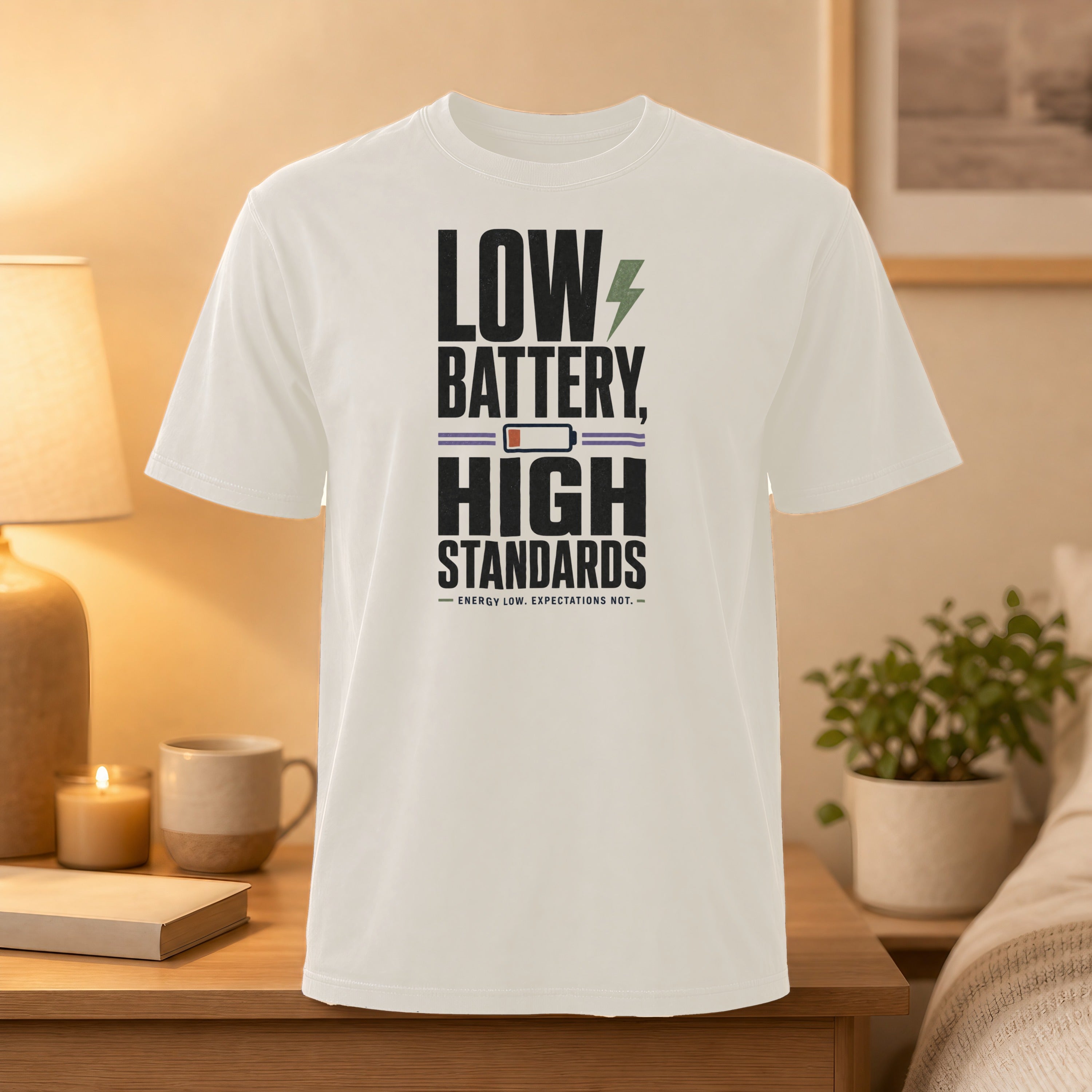 White t-shirt with "LOW BATTERY, HIGH STANDARDS" text and lightning bolt graphic.