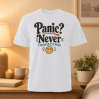 White t-shirt with "Panic? Never Heard Of Her." text and a smiling emoji.