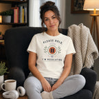 Woman in cream t-shirt with "Please Hold, I'm Regulating" text and pause symbol.