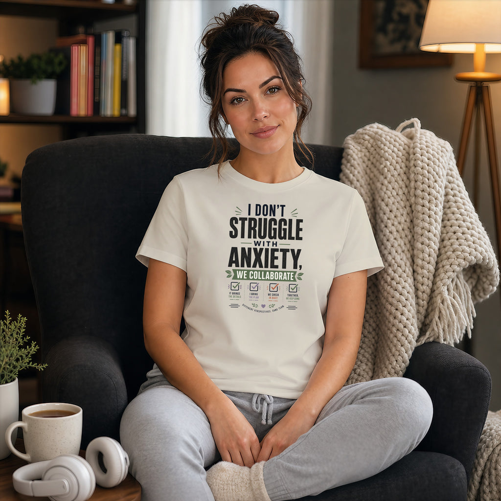 Woman in chair wearing white t-shirt with text about collaborating with anxiety.