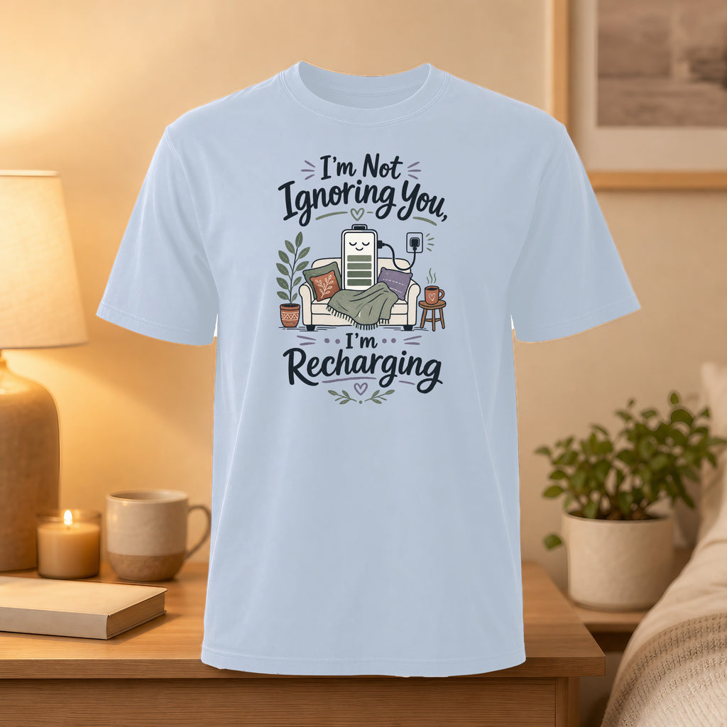 Light blue t-shirt with text "I'm Not Ignoring You, I'm Recharging" and battery illustration.