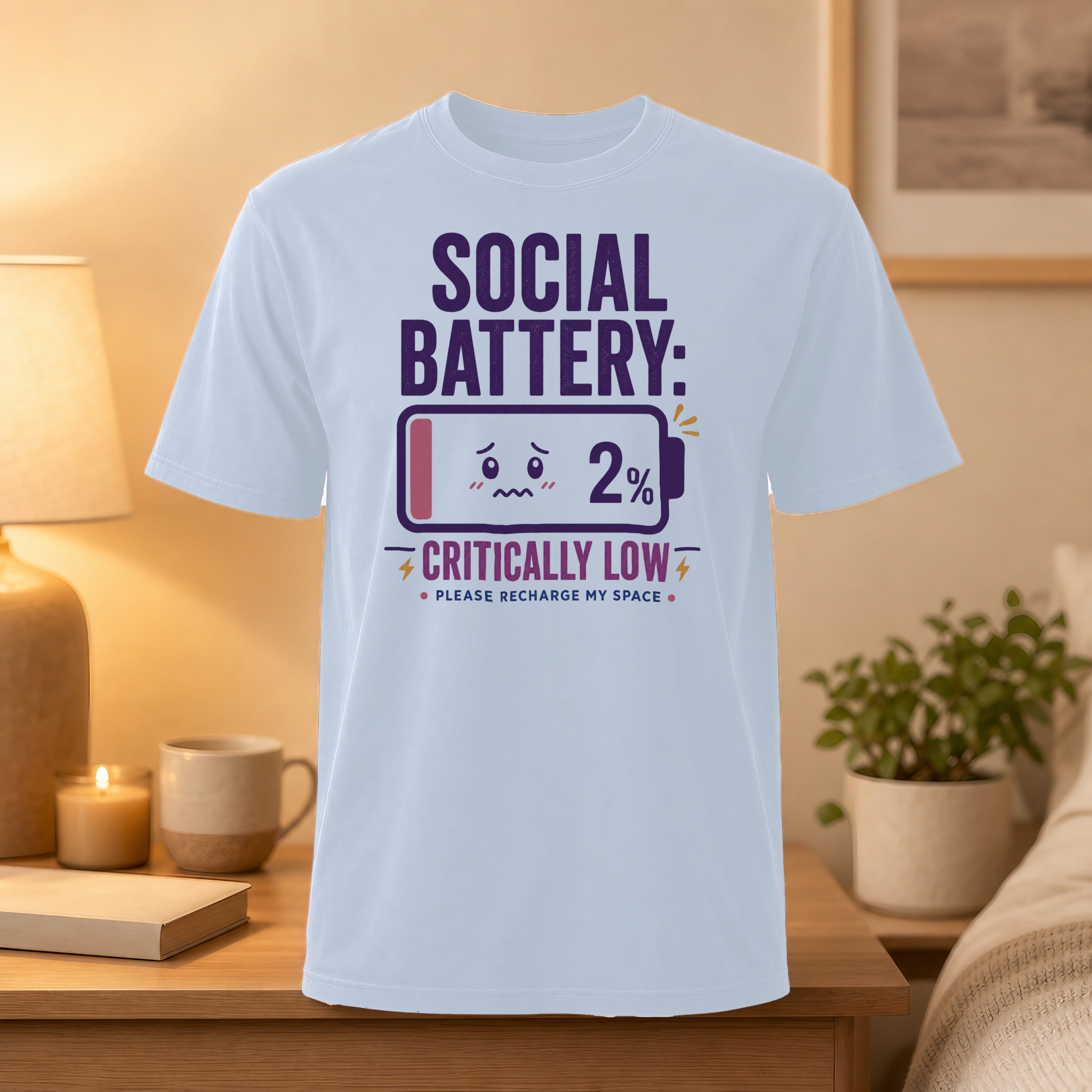 White t-shirt with "SOCIAL BATTERY: 2% CRITICALLY LOW" graphic.