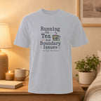White t-shirt with text "Running On Tea And Boundary Issues" and a teacup graphic.