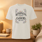 White t-shirt with "Kindness Looks Good On You" text and floral accents.