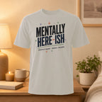 White t-shirt with "MENTALLY HERE-ISH. PHYSICALLY PRESENT... MENTALLY... BUFFERING." text.