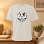 White t-shirt with "I'M FINE ACCORDING TO NO ONE" text on a circular graphic.