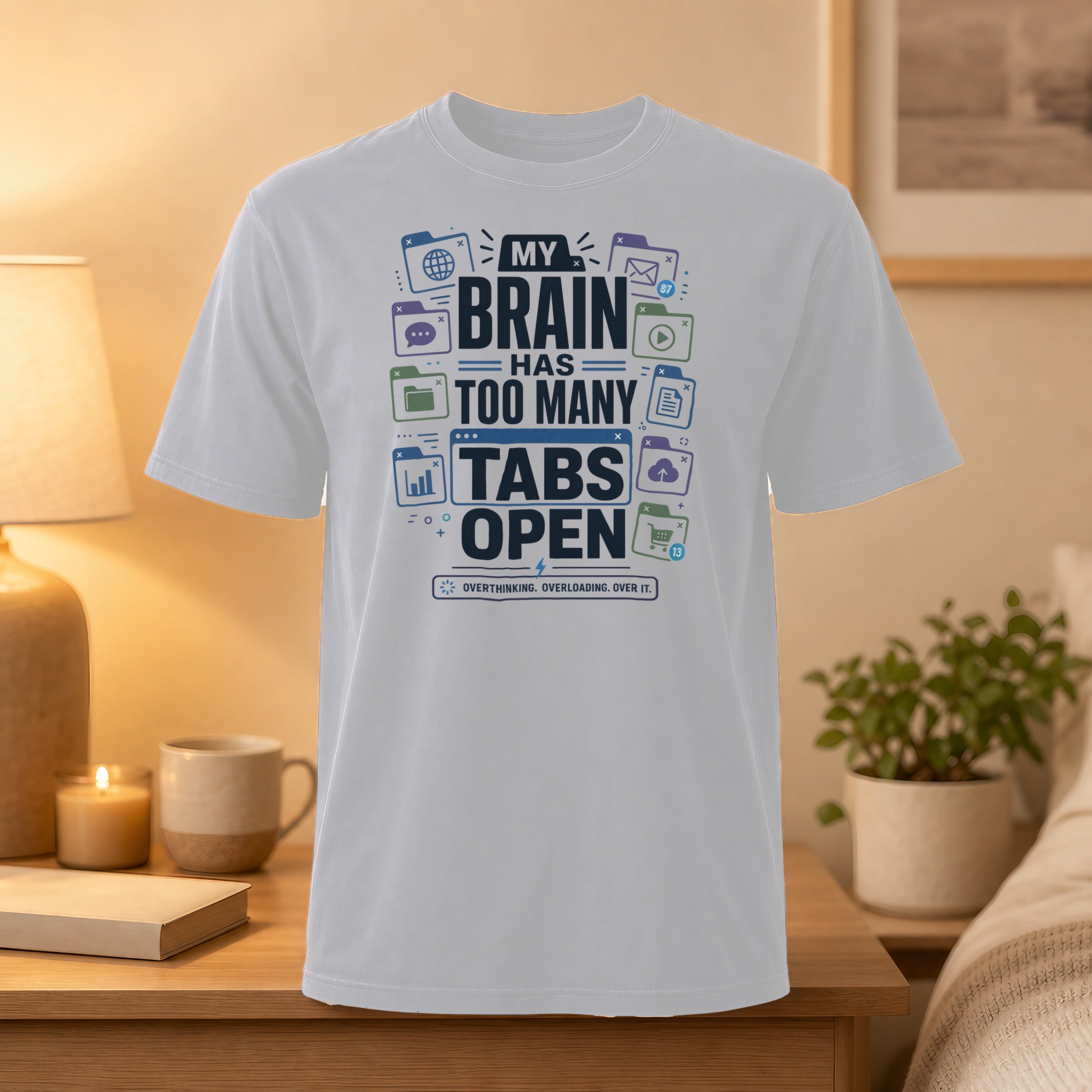White t-shirt with text "My brain has too many tabs open" and icons.