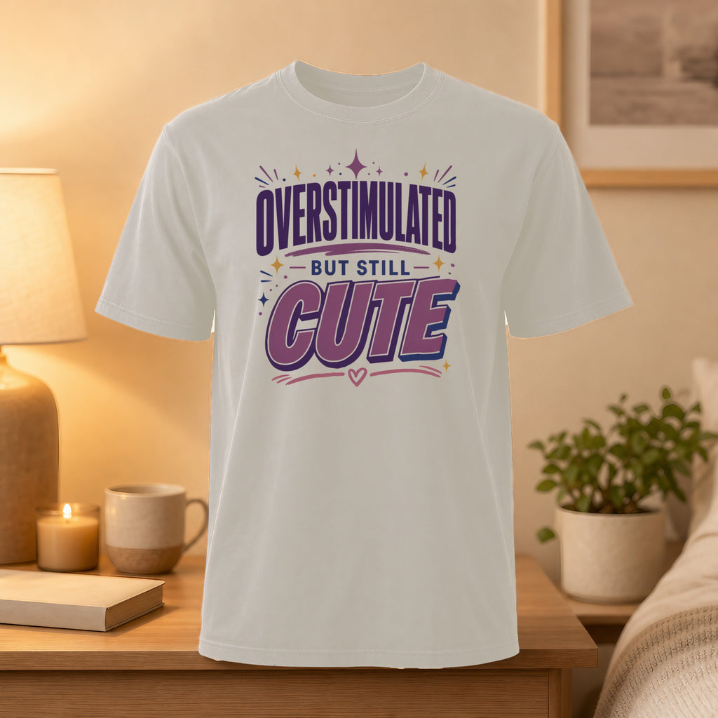White t-shirt with "Overstimulated but still CUTE" text and heart graphic.