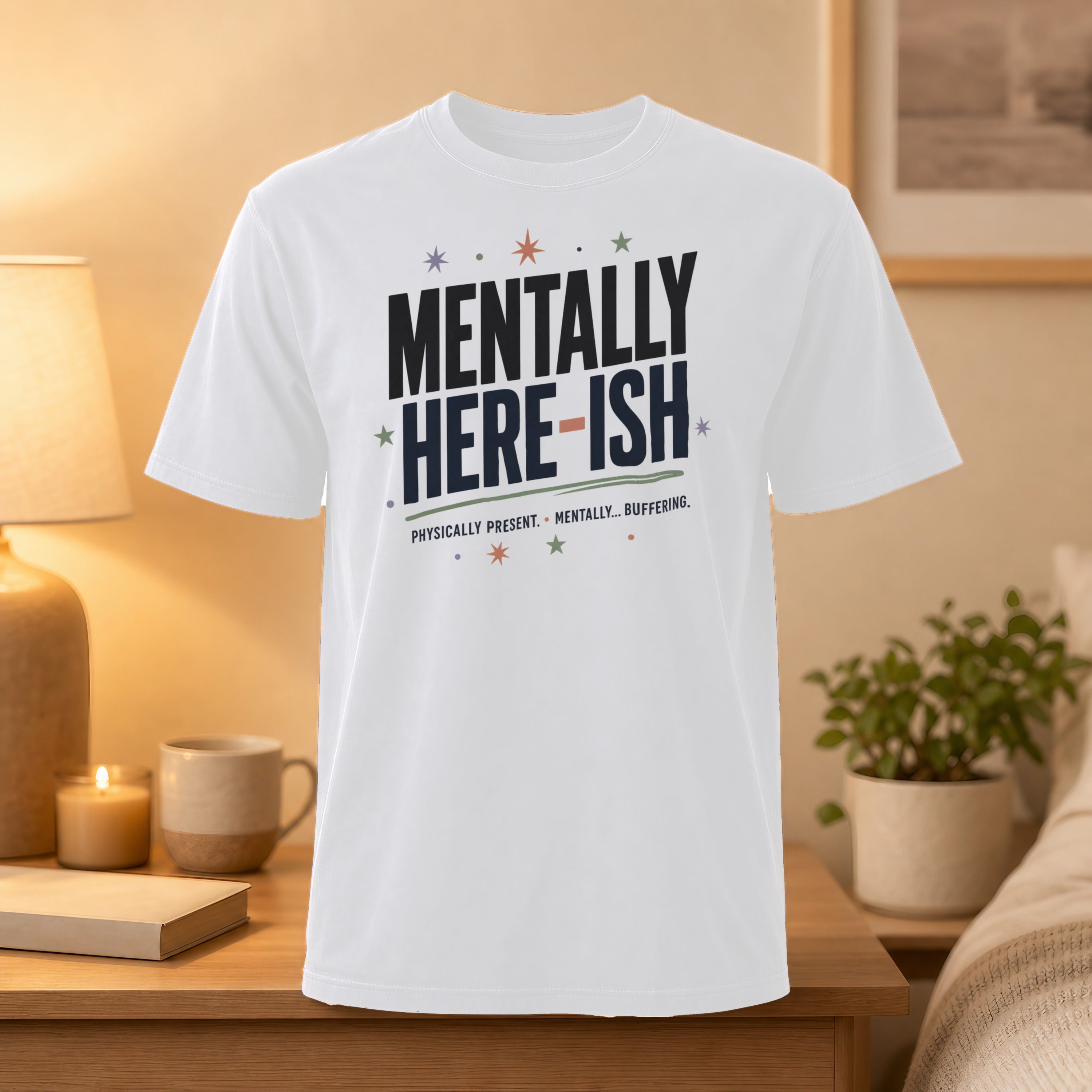 White t-shirt with "MENTALLY HERE-ISH" and "PHYSICALLY PRESENT. MENTALLY... BUFFERING." text.