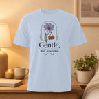 White t-shirt with a floral graphic and "Gentle, Not Available" text.