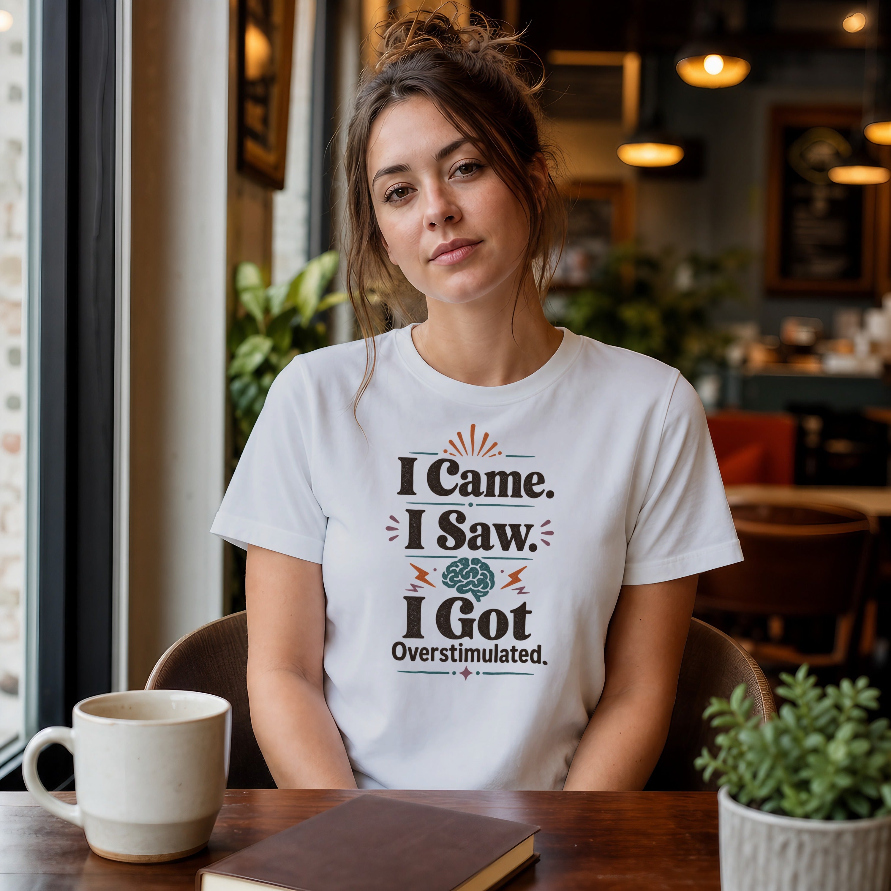 Woman wearing "I Came. I Saw. I Got Overstimulated." t-shirt with brain graphic.