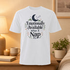 White t-shirt with "Emotionally Available After A Nap" text and moon graphic.