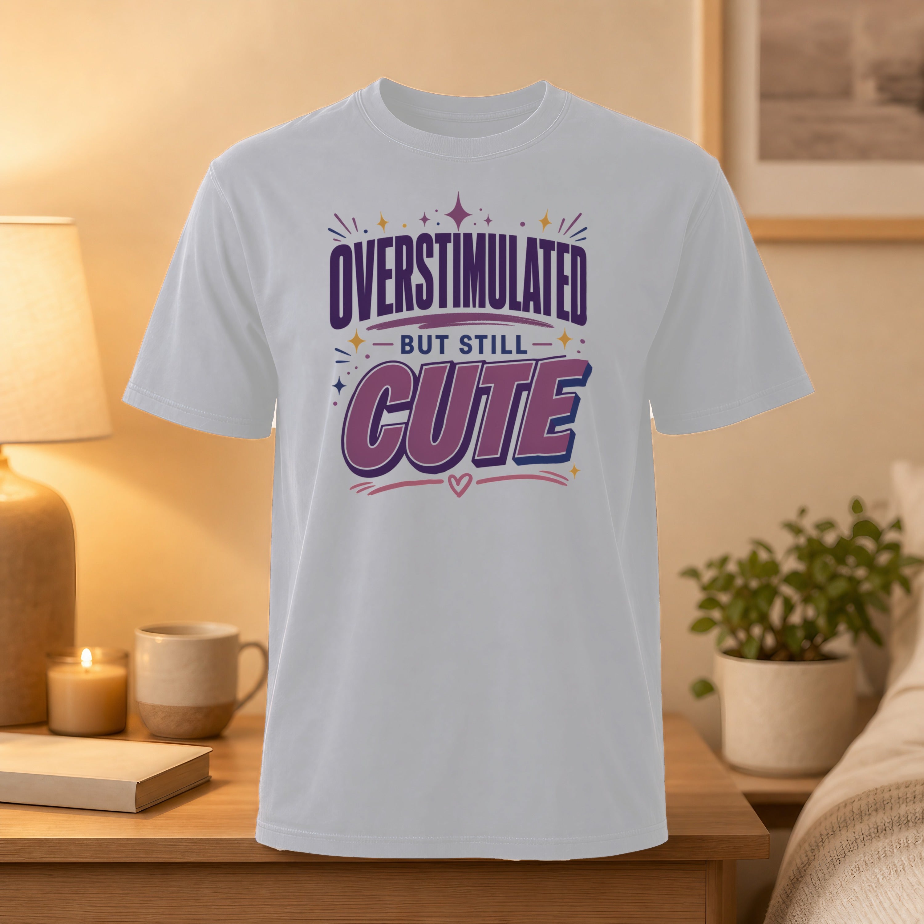 White t-shirt with "OVERSTIMULATED BUT STILL CUTE" text.