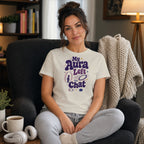 Woman wearing a t-shirt that says "My Aura Left The Chat".