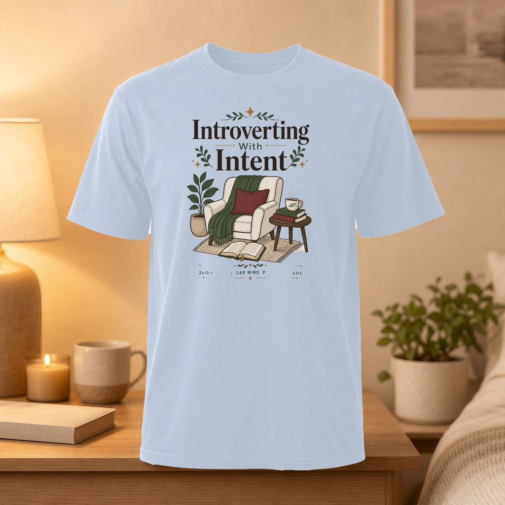 Light blue t-shirt with "Introverting with Intent" text and cozy armchair graphic.