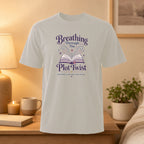 Light grey t-shirt with "Breathing Through the Plot Twist" book design.