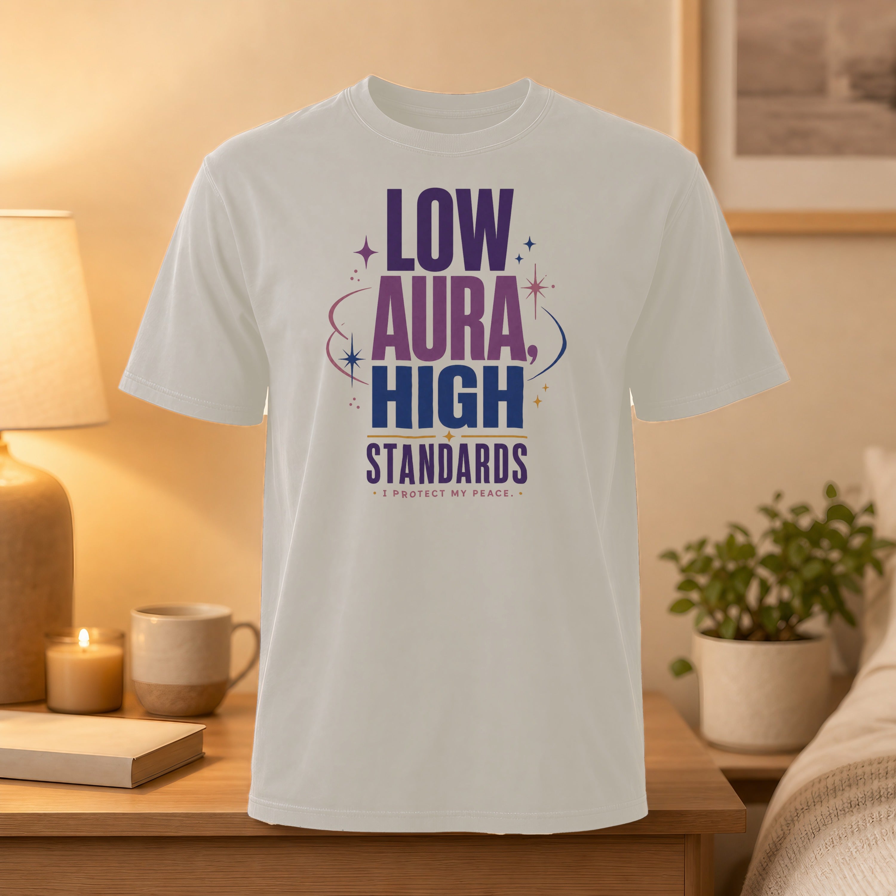 White t-shirt with purple and blue text: "LOW AURA, HIGH STANDARDS * I PROTECT MY PEACE".