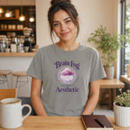 Woman wearing grey t-shirt with "Brain Fog Aesthetic" text and cloud design.