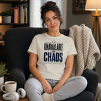 Woman in t-shirt reading "Unavailable for Chaos" sitting in chair.