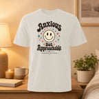 White t-shirt with "Anxious But Approachable" text and a smiley face.