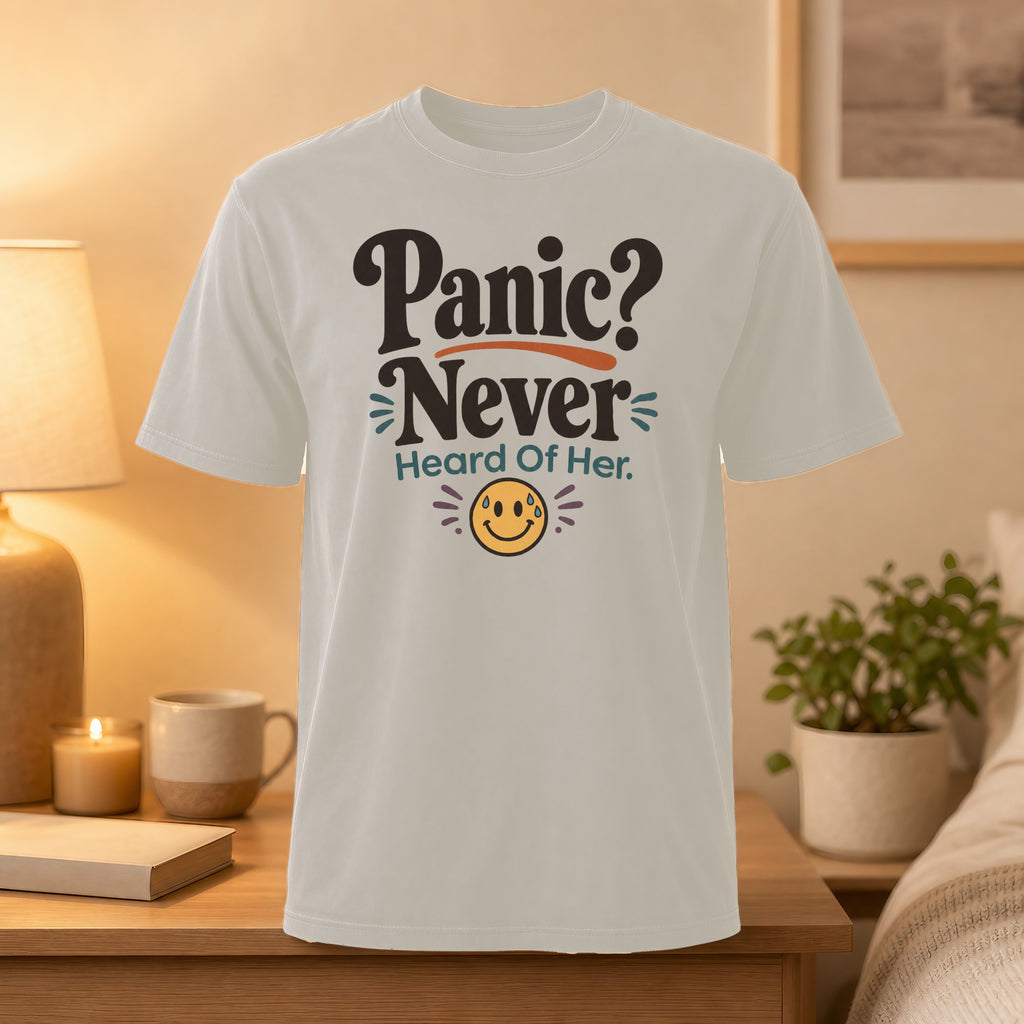 Cream t-shirt with "Panic? Never Heard Of Her." text and smiling emoji.