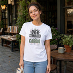 Woman wearing white t-shirt with "Over stimulated is my cardio" text.