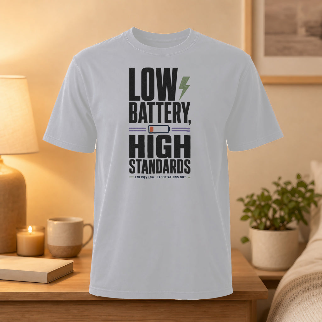 White t-shirt with "LOW BATTERY, HIGH STANDARDS. ENERGY LOW, EXPECTATIONS NOT."