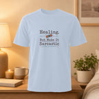 Light blue t-shirt with "Healing, But Make It Sarcastic" text.