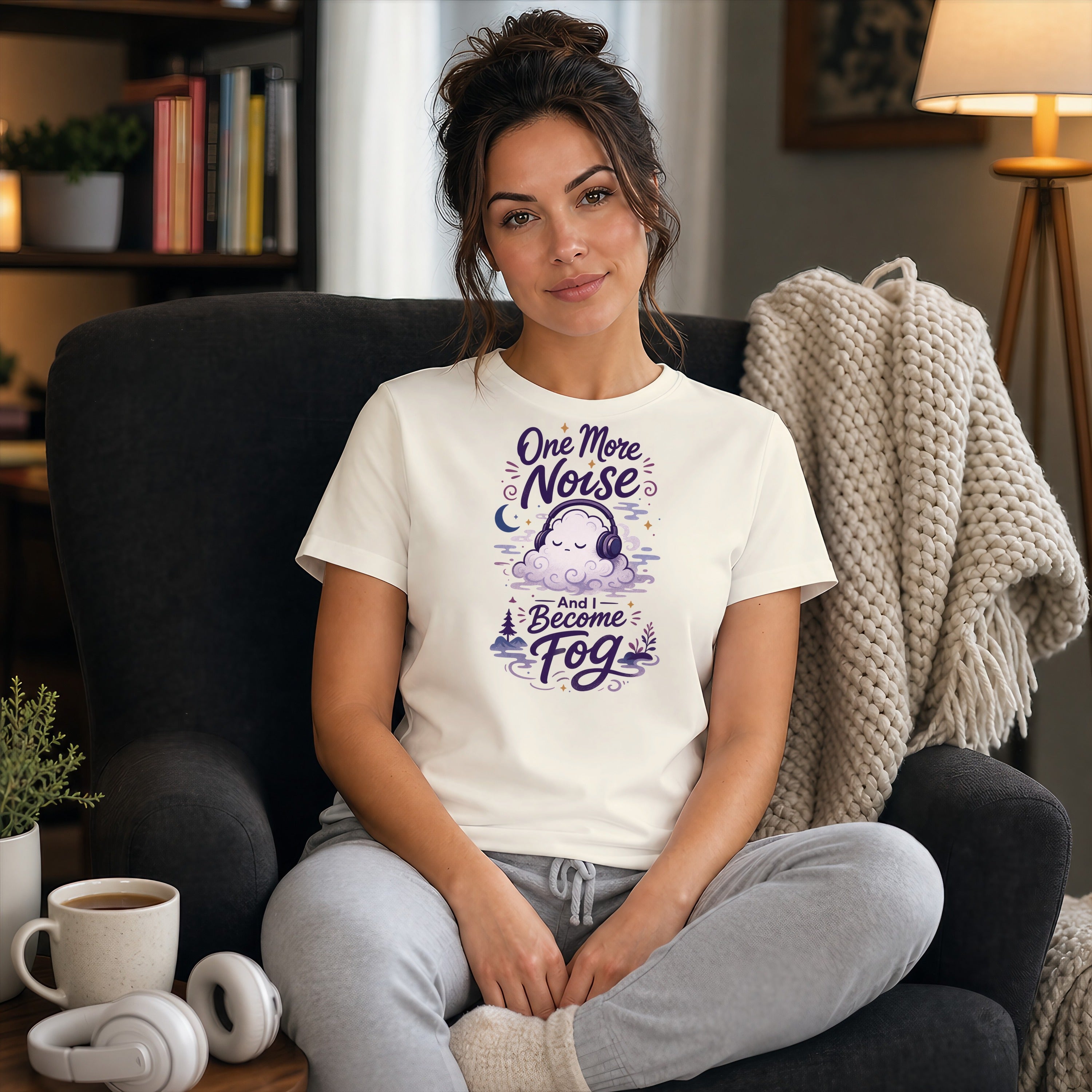 Woman wearing a cream t-shirt with "One More Noise And I Become Fog" text and cloud graphic.
