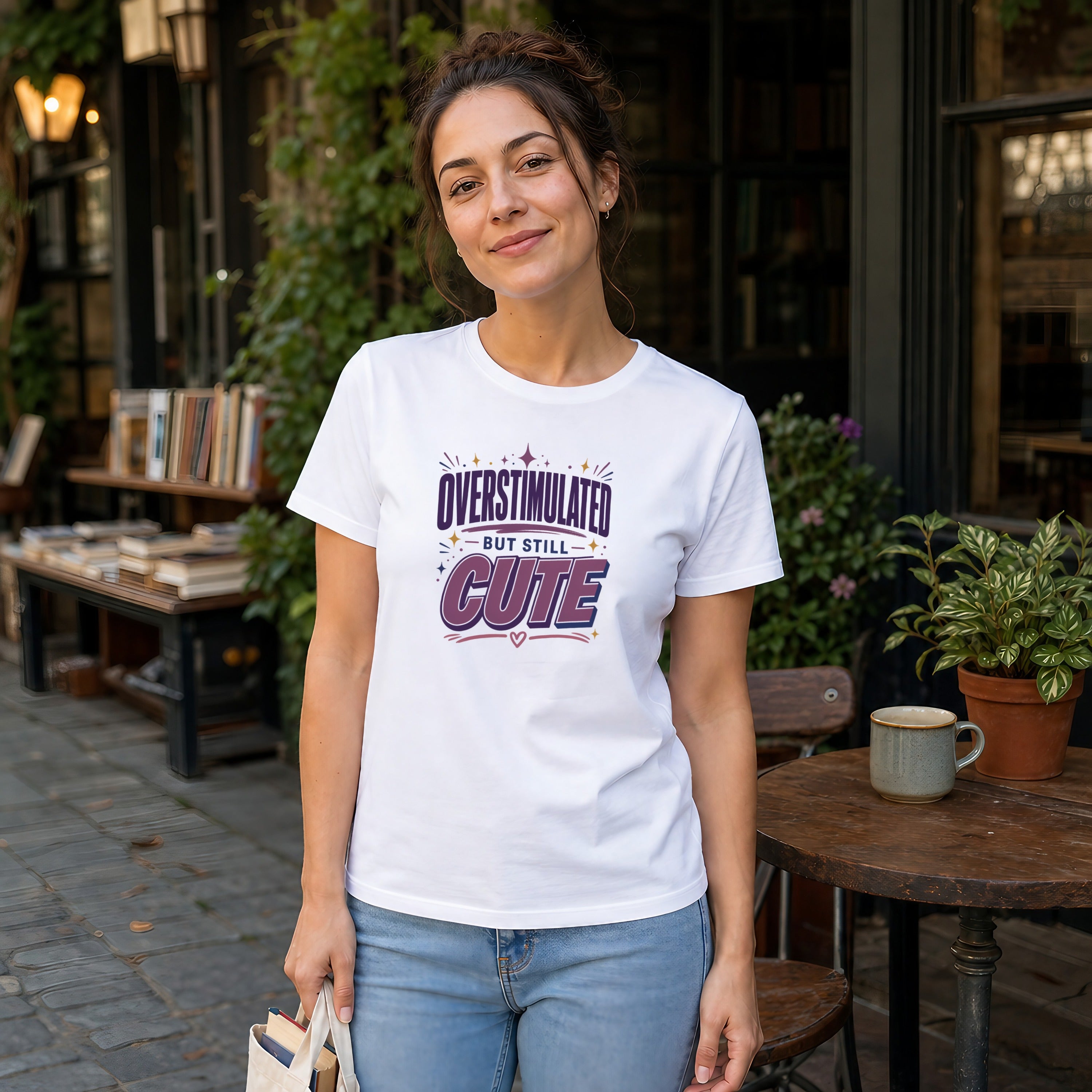 Woman wearing a white t-shirt with "overstimulated but still cute" text design.