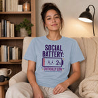Light blue t-shirt with "SOCIAL BATTERY: 2% CRITICALLY LOW" text.