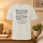 T-shirt with "Existing Quietly Is A Full-Time Job" and a mock timesheet.