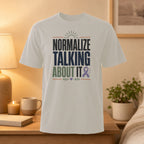 White t-shirt with "Normalize Talking About It" and purple ribbon graphic.