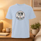 Light blue t-shirt with "I'm Fine According to No One" text in a circular emblem.