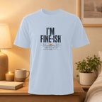 Light blue t-shirt with "I'M FINE-ISH" and "SOME DAYS ARE JUST A LITTLE MORE CREATIVE" text.