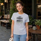 Woman wearing a white t-shirt with text about anxiety collaboration.