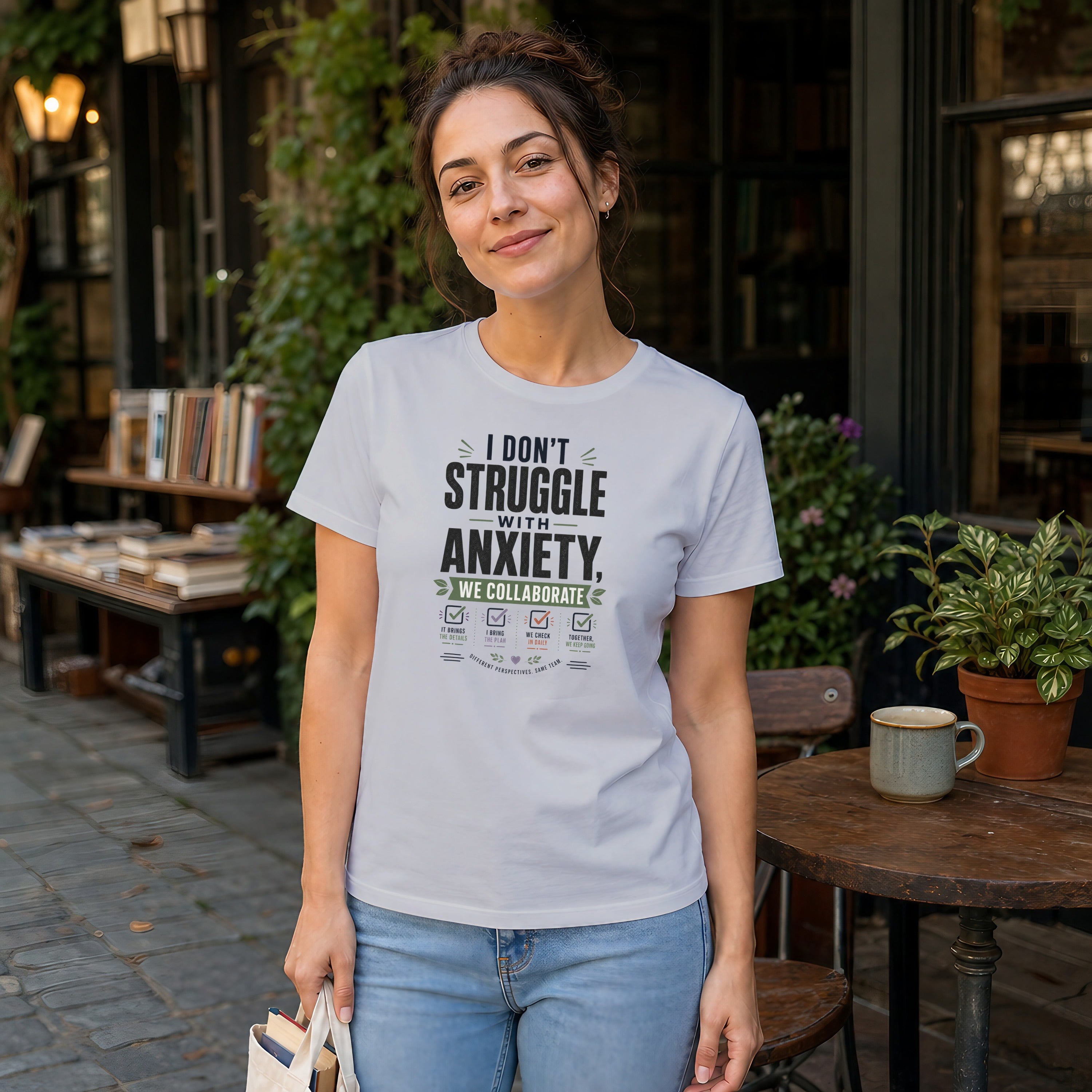 Woman wearing a white t-shirt with text about anxiety collaboration.
