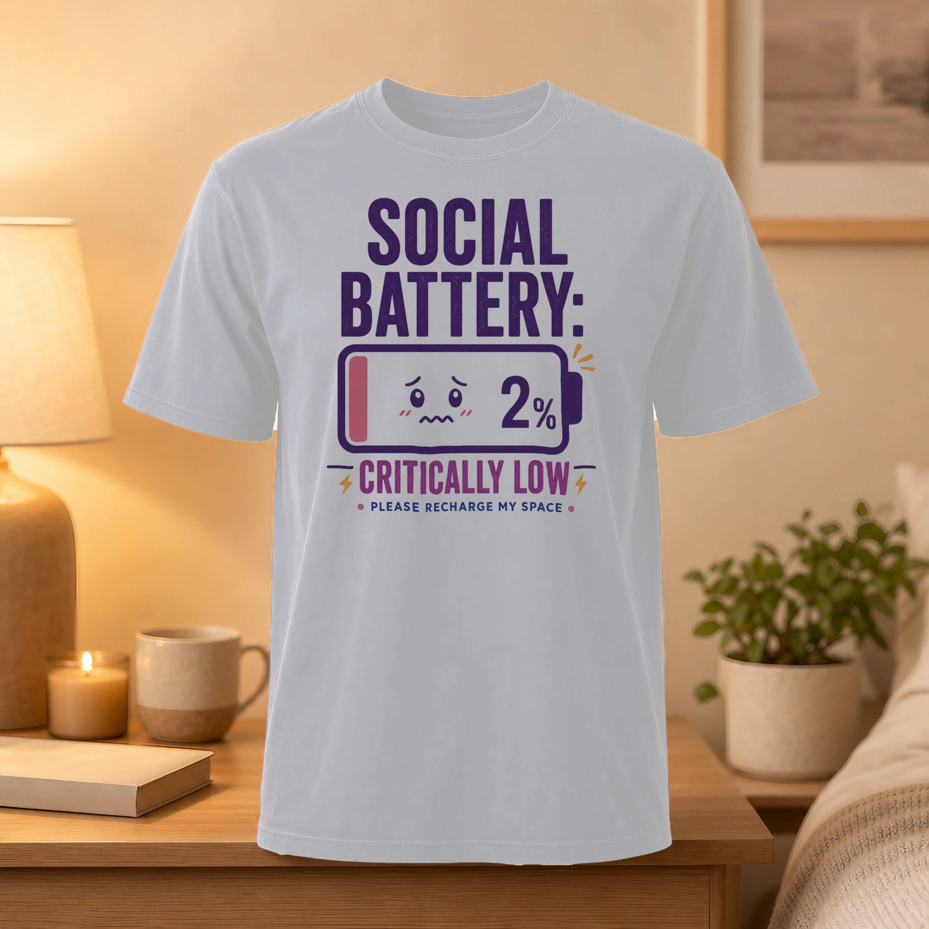 White t-shirt with "SOCIAL BATTERY: 2% PLEASE RECHARGE MY SPACE" graphic.