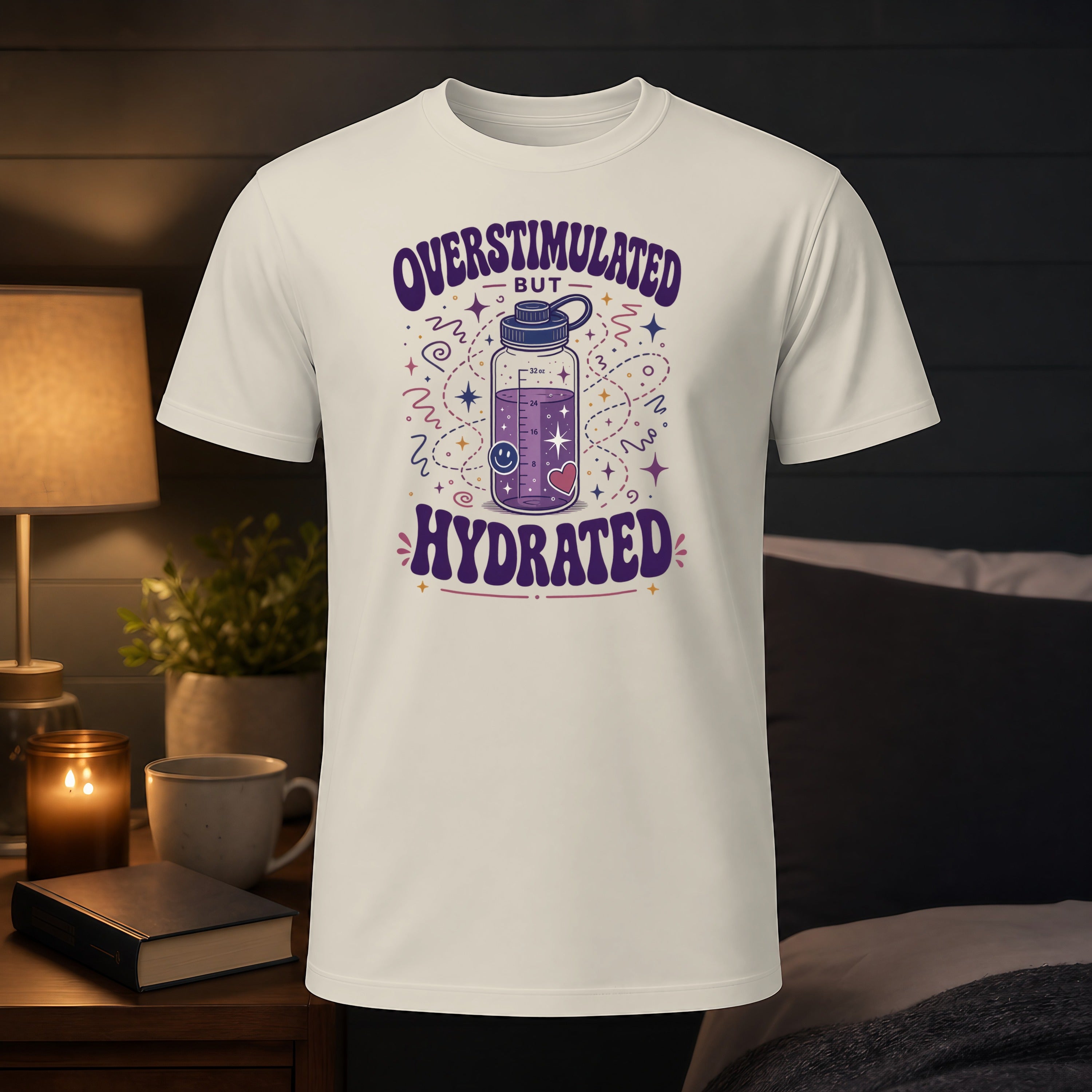 White t-shirt with "Overstimulated but Hydrated" text and water bottle graphic.