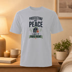 White t-shirt with "Protecting My Peace Like It Pays Rent" text and house graphic.